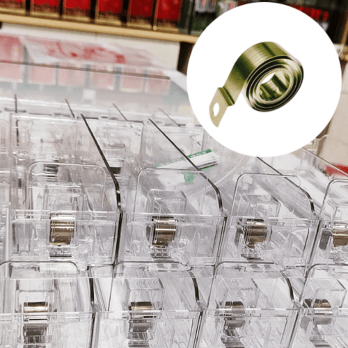 Custom metal pusher spring installed in automatic tobacco dispenser – consistent force for retail shelving – SEME Hardware