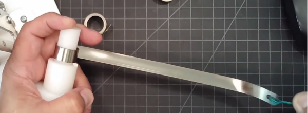 Stainless steel constant force spring for grounding, cable screening, and earthing applications in industrial systems.