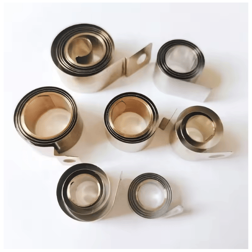 Variable force spring for shelf pusher systems providing smooth and controlled pushing force spring