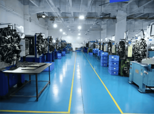 Variable force spring for shelf pusher systems providing smooth and controlled pushing force spring